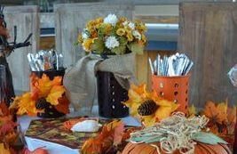 A table set with silverware and flowers.